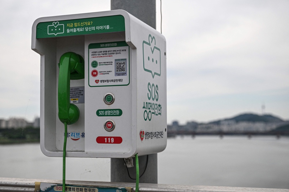 This photo taken on June 24, 2026 shows a suicide-prevention phone installed on a bridge over the Han River in Seoul. — AFP pic