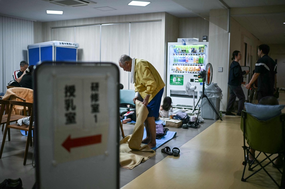 Evacuees rest at a shelter in Uki, Kumamoto Prefecture, on July 29, 2026, a day after an earthquake struck southwestern Japan. — AFP pic