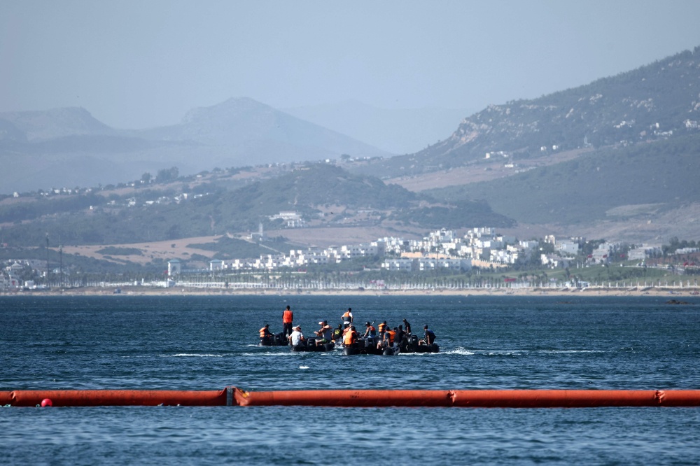 People aboard inflatable boats navigate on the Moroccan side of the new floating barrier deployed by Spain to reinforce security near the border post of the Spanish enclave of Ceuta on August 2, 2026. — AFP pic