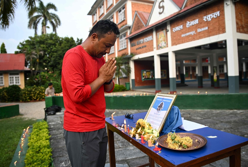 Nirmal Purja’s classmate Dhiraj Bahadur Panta pays tribute to the mountaineer and nine others killed in an avalanche in Pakistan, at Small Heaven School in Chitwan on August 2, 2026. — AFP pic