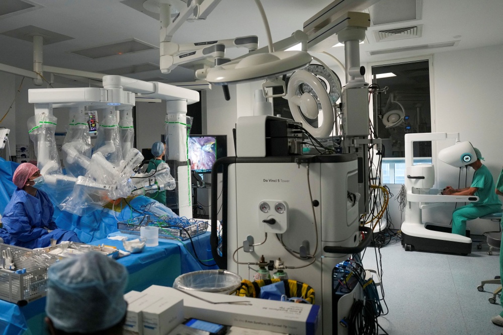 Surgeon and director of robotic surgery Sasha Stamenkovic (far right) performs lung cancer surgery using the new Da Vinci 5 robotic-assisted surgical system at St Bartholomew’s Hospital in London on July 3, 2026. — AFP pic