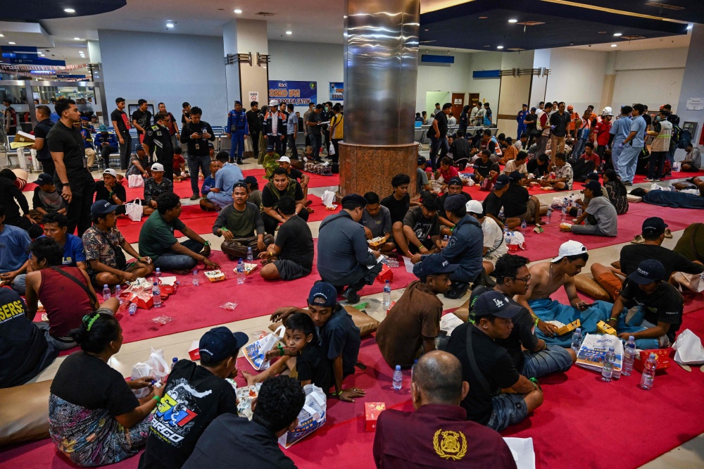 Survivors of the Mutiara Sentosa 2 ferry which caught fire in the waters off Madura island, East Java, on August 2, 2026, gather at Tanjung Perak port in Surabaya early on August 3, 2026. — AFP pic 