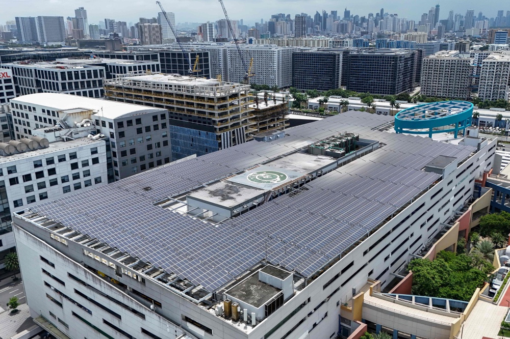 An aerial photo shows solar panels on the roof of SM Mall of Asia in Pasay, Metro Manila on July 13, 2026. — AFP pic