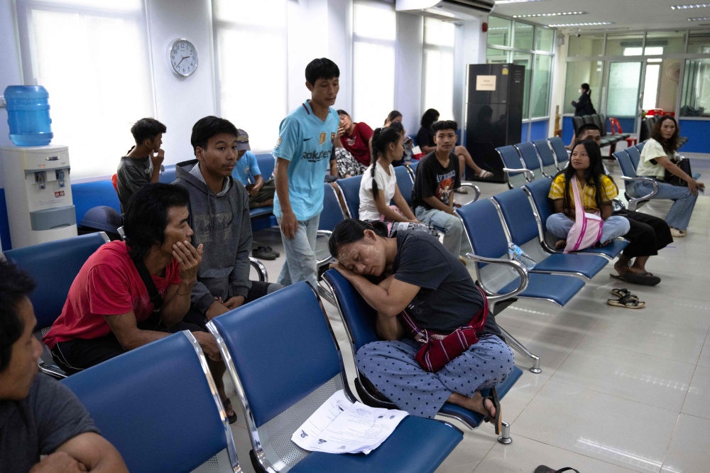 Karen refugees from the Mae La refugee camp along the Thai-Myanmar border wait inside a district office to register for Thai ID cards issued to foreigners granting them permission to work, in Prachinburi province on July 1, 2026. — AFP pic