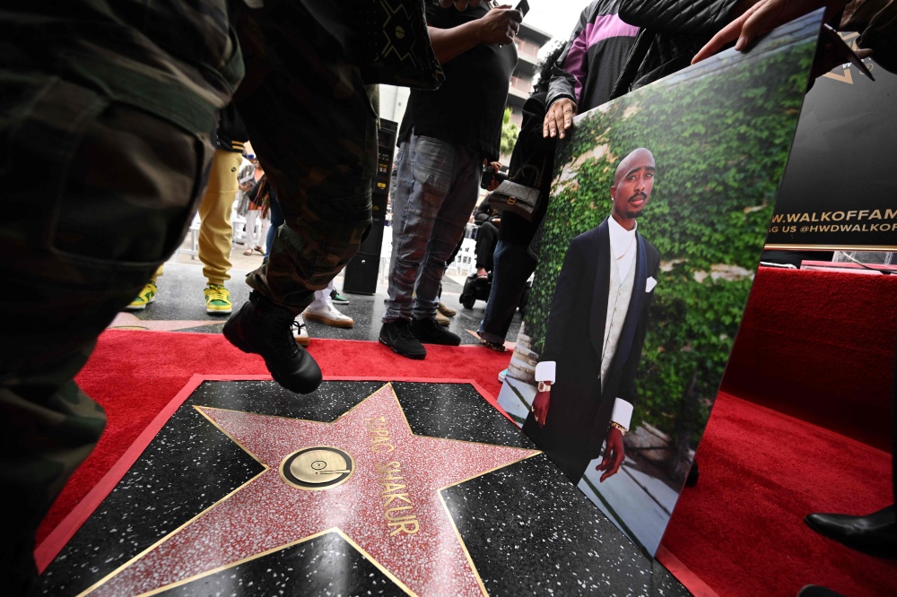 A portrait of US rapper Tupac Shakur is displayed at his unveiled star on the Hollywood Walk of Fame ceremony in Hollywood, California on June 7, 2023. — AFP pic