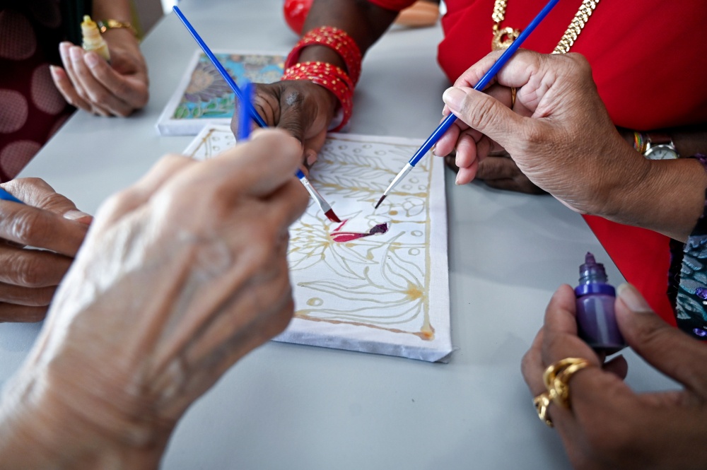 Older Malaysians from various ethnic backgrounds taking part in a batik-themed colouring activity at Halaman Suri Sejahtera Negeri Perak in Taman Lapangan Terbang recently. — Bernama pic 