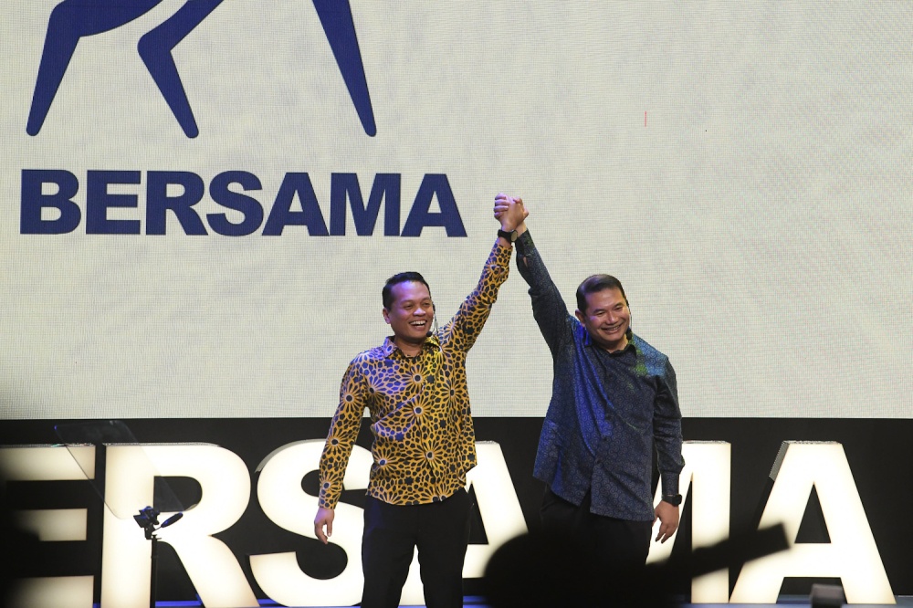 (From left) Nik Nazmi Nik Ahmad and Datuk Seri Rafizi Ramli raise their hands together on stage during the official launch of the new political branding, Bersama, at the PJ Performing Arts Centre in Petaling Jaya on May 17, 2026. — Picture by Raymond Manuel