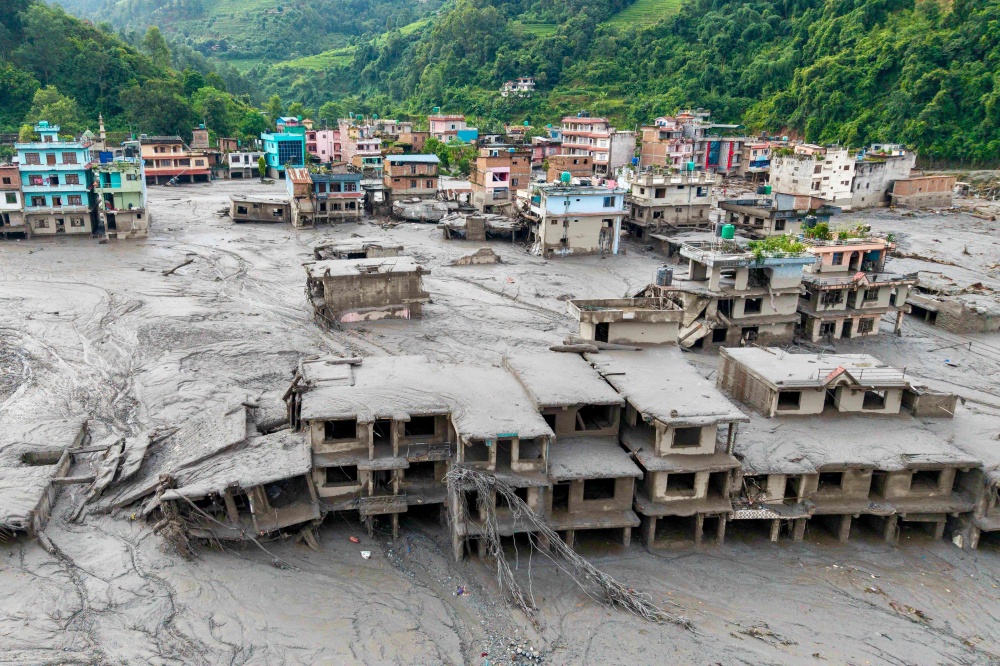 An aerial view shows houses lying deluged in sludge after flash floods at Devighat, Bidur Municipality in Nepal’s Nuwakot district on August 27, 2026. — AFP pic
