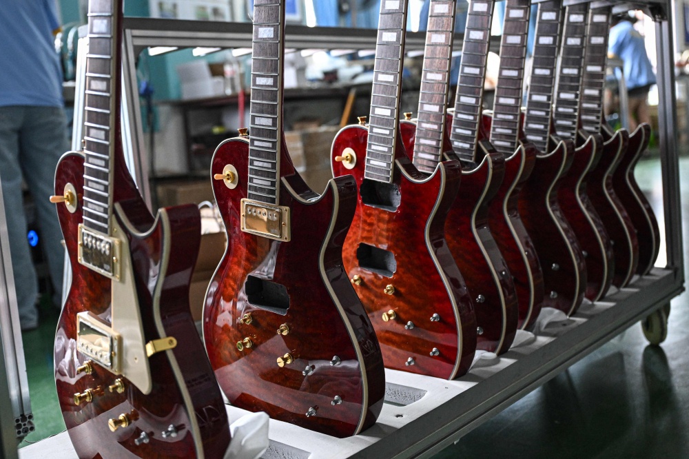 This photo taken on July 27, 2026 shows newly produced guitars lined up at a factory of Shenqu musical instrument manufacturer in Zheng’an, in south-western China’s Guizhou Province. — AFP pic