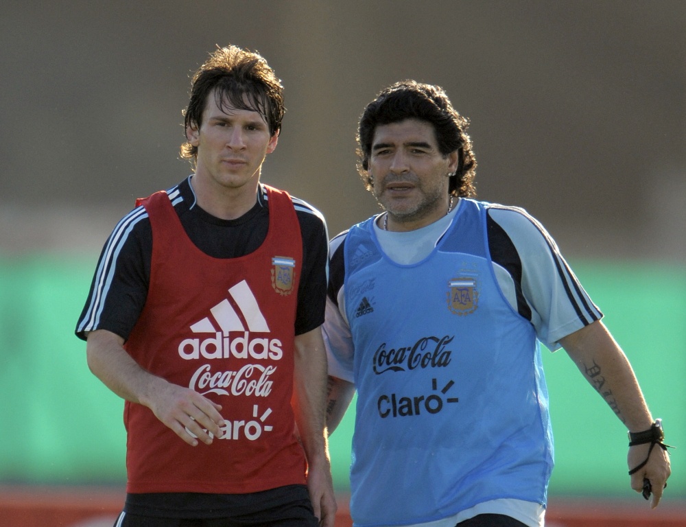 File photo shows Diego Maradona speaking with Lionel Messi during a training session in Buenos Aires, March 24, 2009. — AFP pic