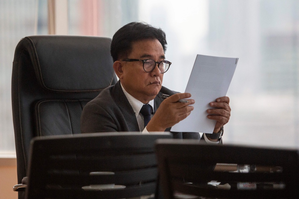Indonesia’s coordinating minister for law, human rights, immigration and correctional institutions Yusril Ihza Mahendra reads documents before an interview with AFP at his office in Jakarta on July 9, 2026. Indonesia has witnessed a spate of public attacks on transgender women and gay people, pushing the community further into the shadows. — AFP pic