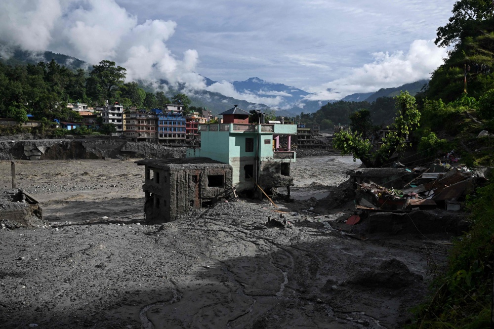 A turquoise-green house stands tall amid sludge near Trishuli river in the aftermath of flash floods at Trishuli Center in Nepal’s Nuwakot district September 2, 2026. — AFP pic 
