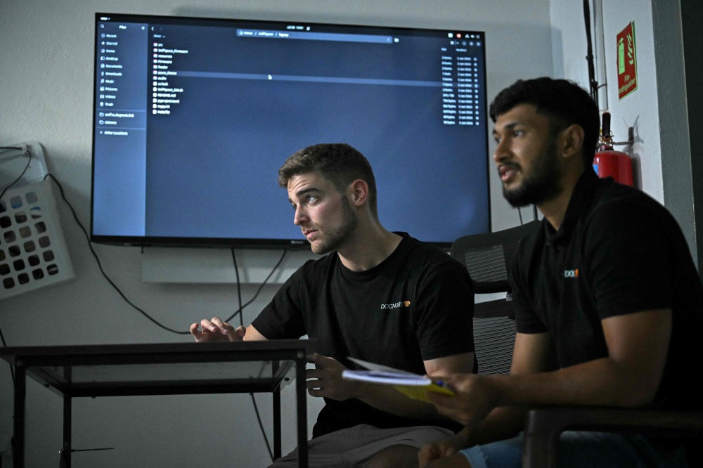 This photograph taken on July 28, 2026 shows co-founder of the Dognosis Itamar Bitan (left) and his team member observing a test procedure at their facility in Kempohalli village on the outskirts of Bengaluru. — AFP pic 