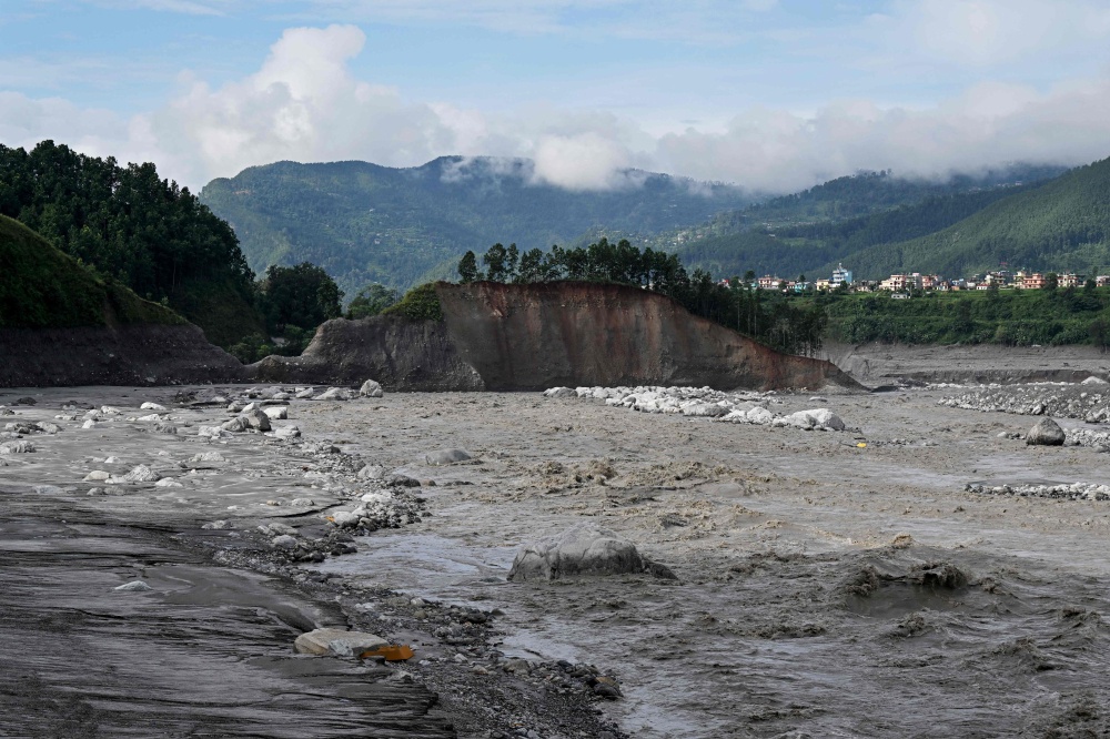 Accumulated sludge lines the Trishuli riverbank after flash floods at Trishuli Bazar in Nepal’s Nuwakot district on September 5, 2026, as survivors struggle to rebuild homes destroyed by the disaster. — AFP pic