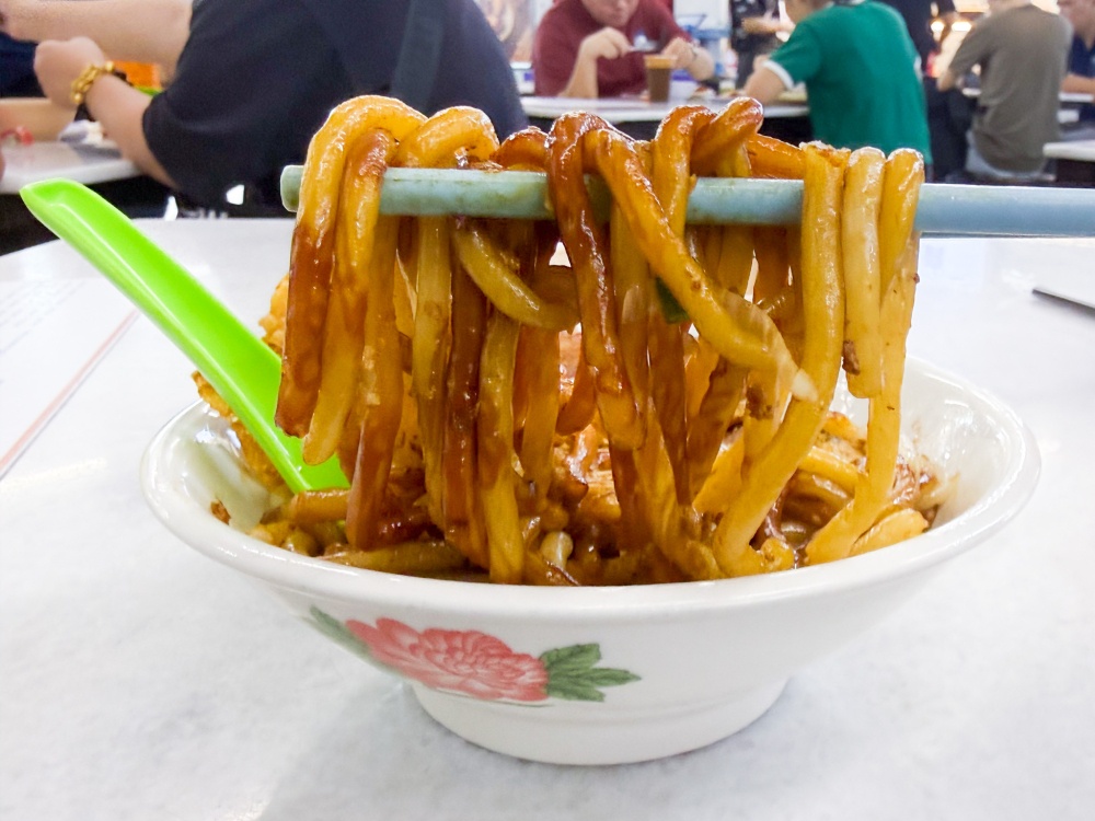 Fat spaghetti-like strands are coated with a slightly sweet dark soy sauce. — Picture by Lee Khang Yi 