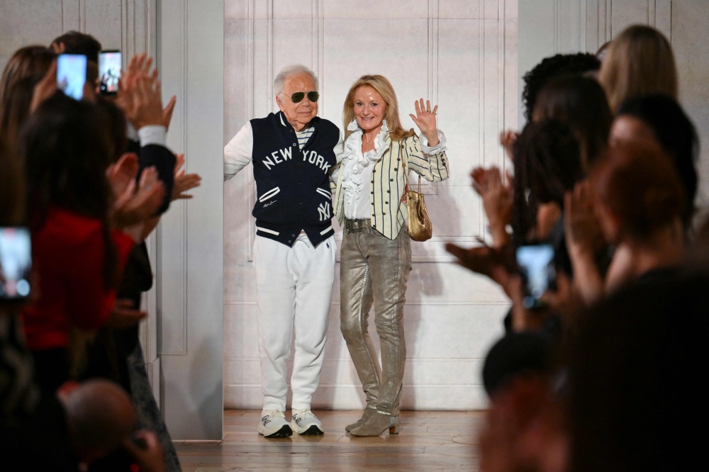 Fashion designer Ralph Lauren and his wife Ricky Lauren wave from the runway during the Ralph Lauren Spring 2027 Collection show during New York Fashion Week in New York on September 9, 2026. — AFP pic