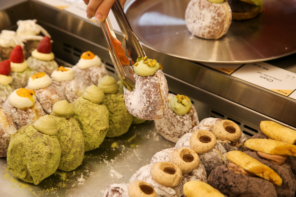 Don't forget the delectable filled donuts, a range of different flavours that include the Cham, inspired by the coffee-tea combined drink, and the Pandan Coconut Cream, which has toasted grated coconut inside a pandan flavoured donut and coconut cream topped with fresh coconut flesh. — Picture by Choo Choy May