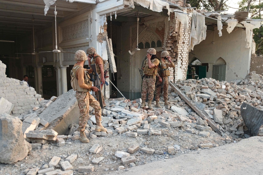 Pakistani soldiers stand amid rubble at the police headquarters in Kohat, Khyber Pakhtunkhwa province, on September 18, 2026, after a militant attack that killed at least 31 people and injured more than 100. — AFP pic