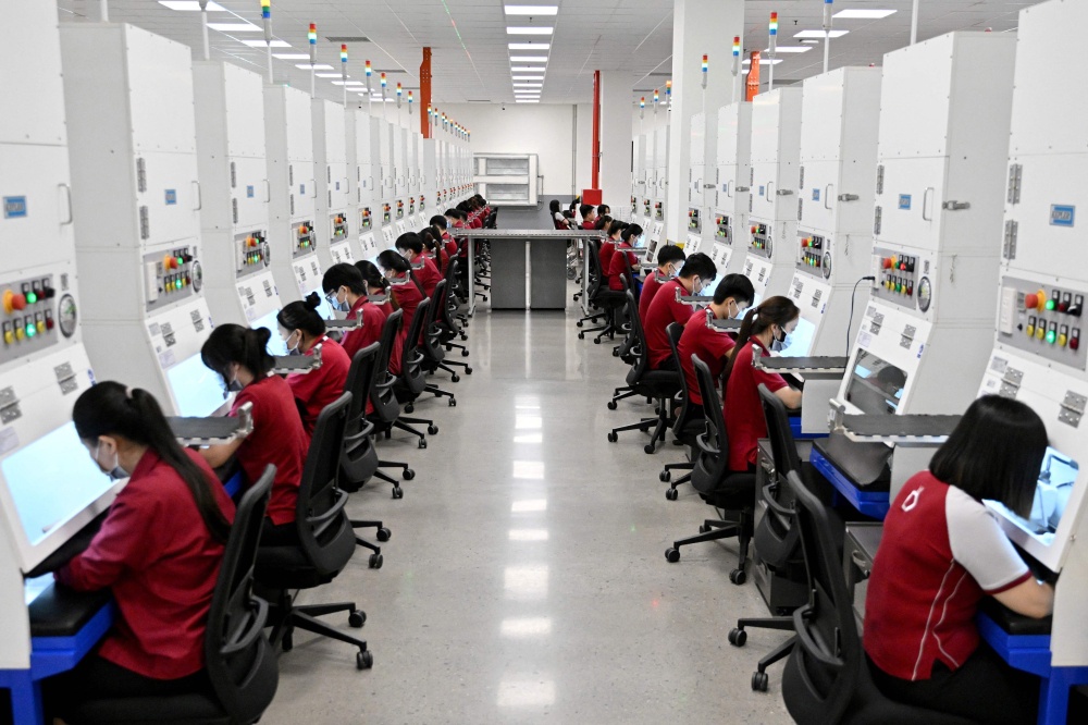 Workers craft jewellery at Pandora's new manufacturing plant in Ho Chi Minh City on October 1, 2026, as the world's biggest jewellery brand opened the facility it said will be able to produce up to 60 million pieces each year. — AFP pic