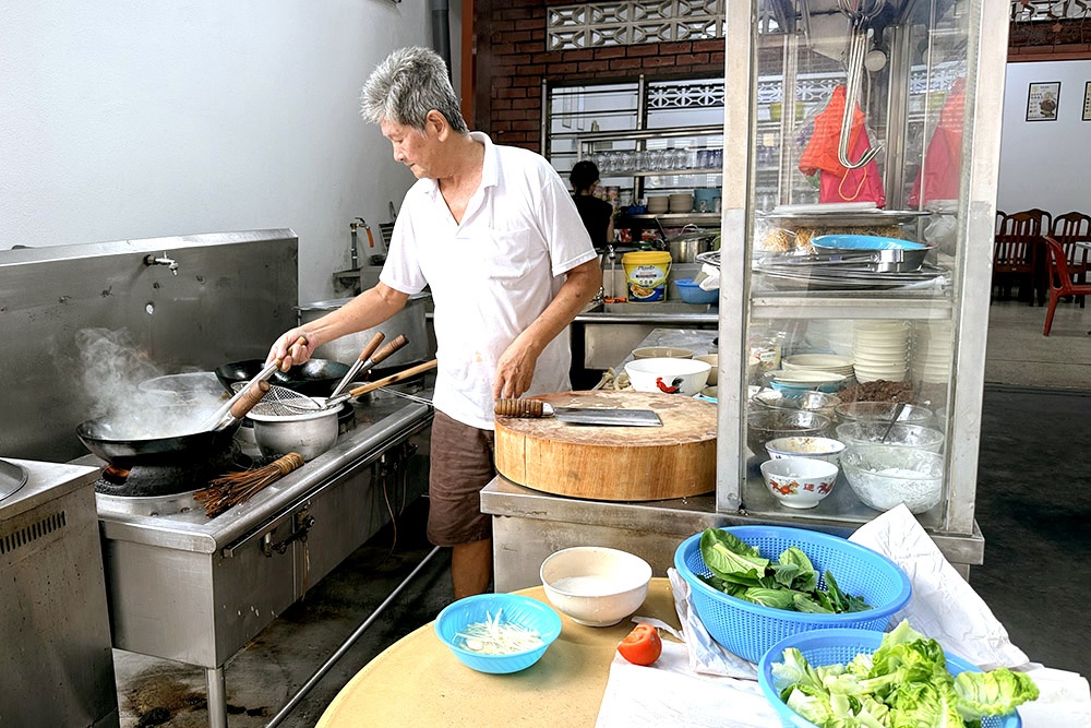Cooking every plate of noodles to order. — Picture by CK Lim