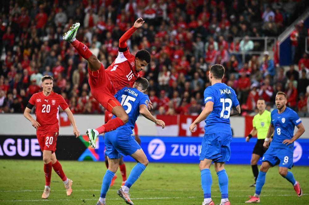 Switzerland’s defender #16 Zachary Athekame (left) and Slovenia’s midfielder #15 Danijel Sturm fight for the ball during the Uefa Nations League Group B1 football match between Switzerland and Slovenia at the Thermoplan Arena in Lucerne October 3, 2026. — AFP pic