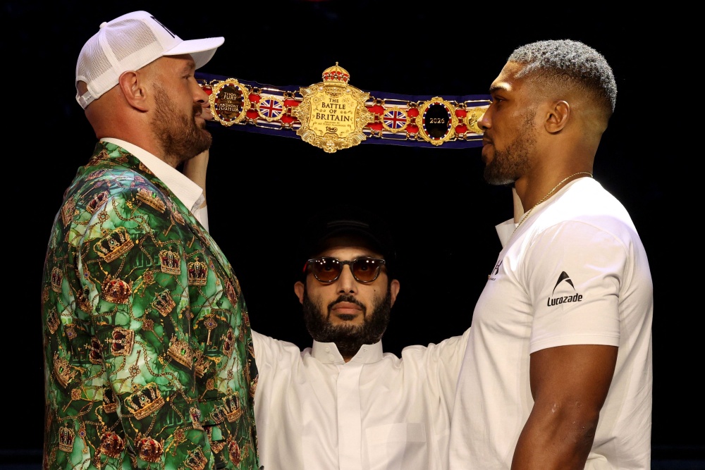 British heavyweight boxers Tyson Fury (left) and Anthony Joshua face off following a press conference in London on September 30, 2026, ahead of their highly anticipated heavyweight boxing fight in Wales in December. — AFP pic
