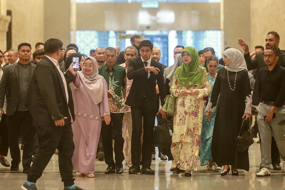 Syed Saddiq along with his supporters and family as well as Bella Astillah as they arrived at the Palace of Justice for his court proceeding in July this year. — Picture by Sayuti Zainudin