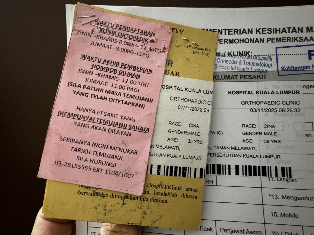 Paper appointment cards and clinic documents from Hospital Kuala Lumpur, where patients may still need to keep physical records for appointments and follow-up care. — Picture by Soo Wern Jun