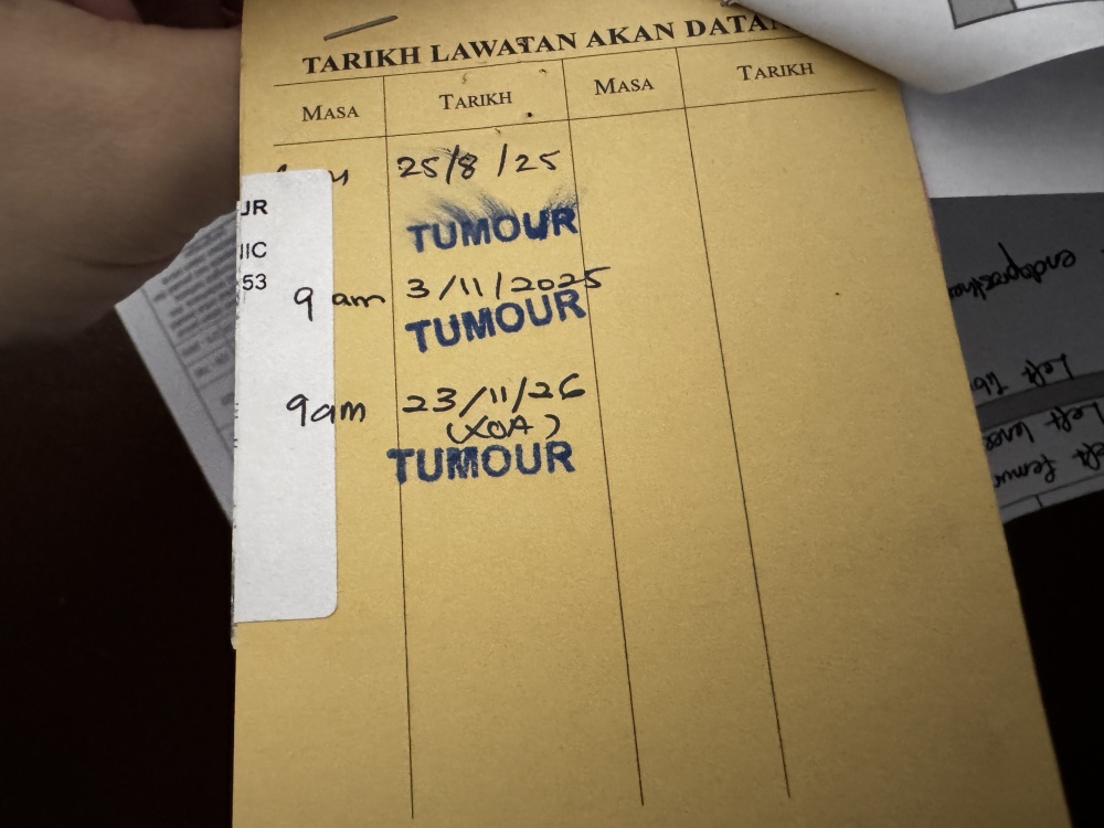 A handwritten appointment card from Hospital Kuala Lumpur shows follow-up dates recorded manually, underscoring the continued role of paper records in parts of the public healthcare system. — Picture by Soo Wern Jun