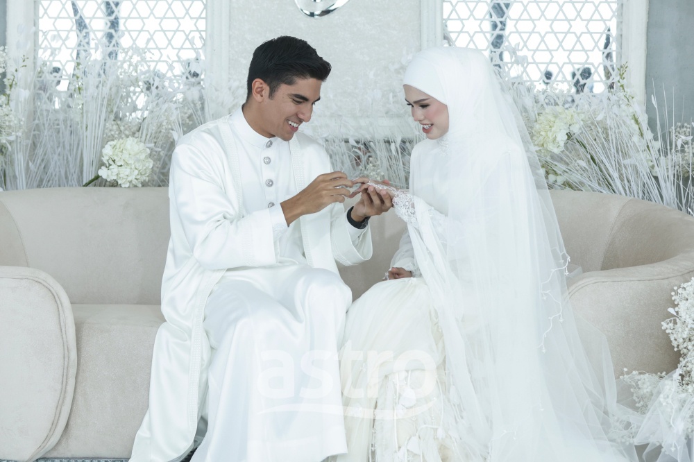 Syed Saddiq slips a ring onto Bella Astillah’s finger during their wedding ceremony at Merdeka 118 in Kuala Lumpur October 10, 2026. — Picture courtesy of Astro