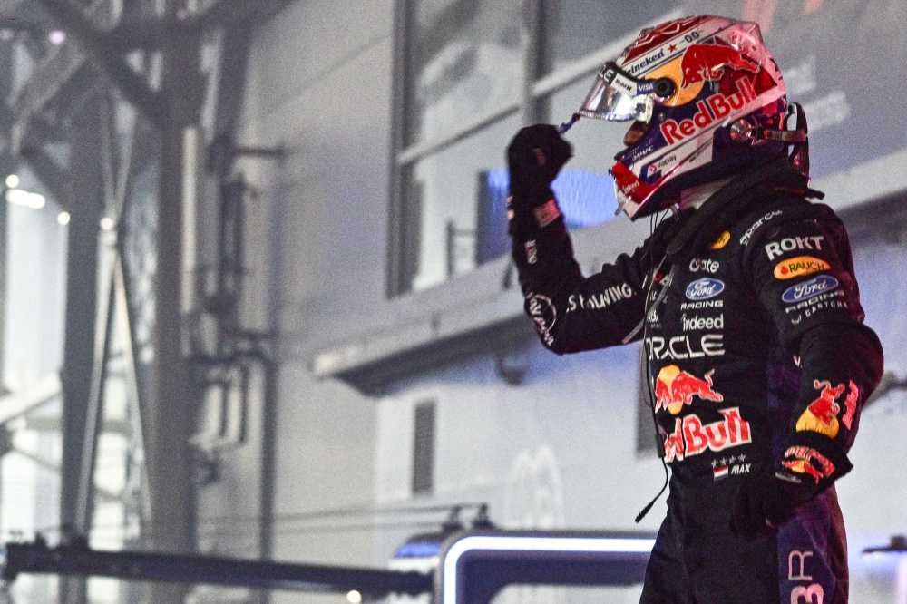 Red Bull Racing’s Dutch driver Max Verstappen waves to supporters as he celebrates his victory on the podium after the Formula One Singapore Grand Prix at the Marina Bay Street Circuit in Singapore on October 11, 2026. — AFP pic