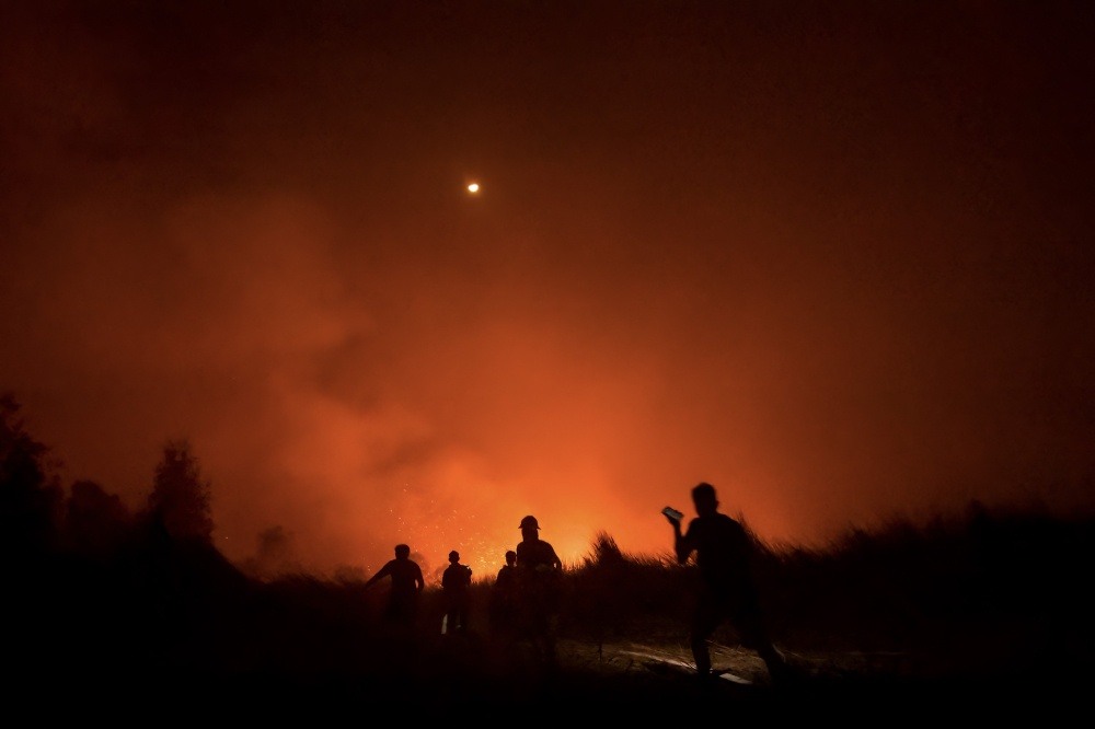 Local residents and volunteer firefighters battle a peatland fire in Gambut village, Banjar, South Kalimantan, Indonesia, on October 2, 2026. — AFP pic