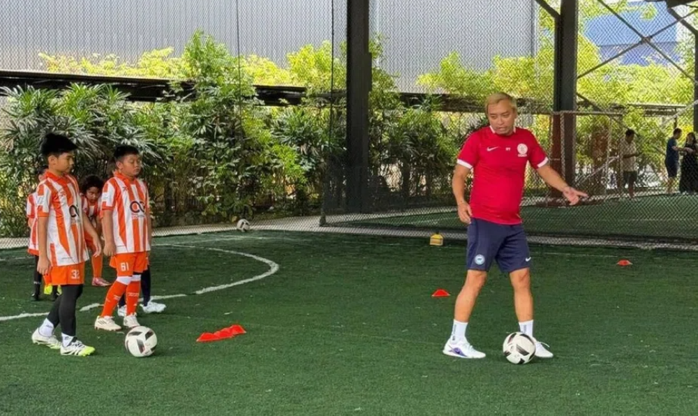 Roslee Tay (right) founded the Football Code Academy in Iskandar Puteri, Johor in January 2026, saw growing demand for structured football training for children. — Picture by Roslee Tay via AsiaOne