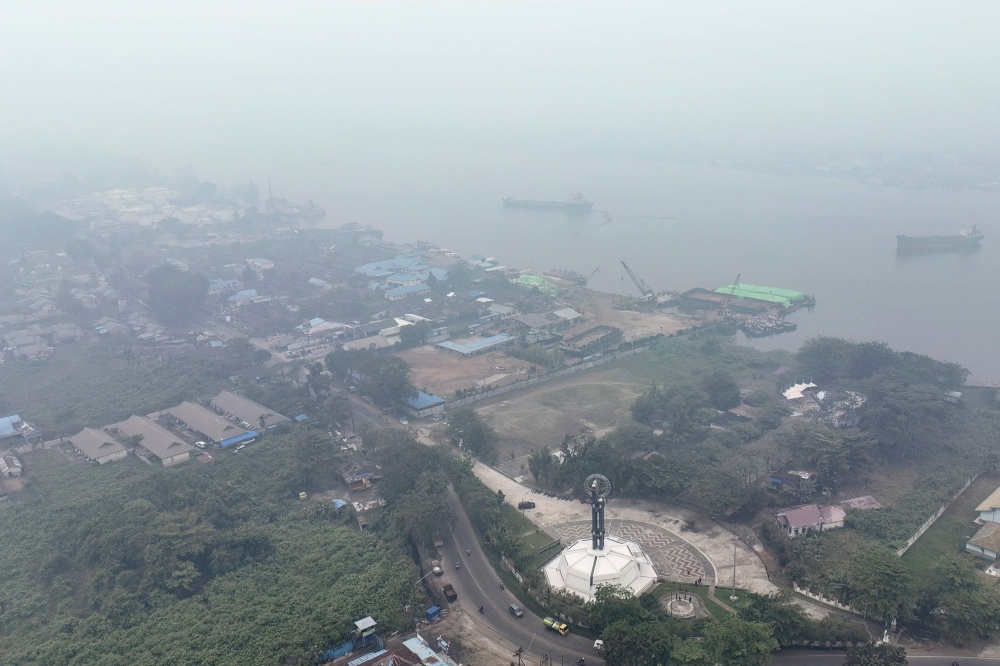 This aerial picture shows smoke shrouding the Equator Monument and the city of Pontianak in West Kalimantan on September 17, 2026. — AFP pic
