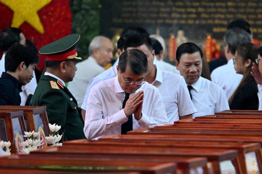 Vietnam’s Prime Minister Le Minh Hung pays his respects with folded hands as he passes caskets bearing the remains of fallen soldiers at Le Thi Rieng Park in Ho Chi Minh City October 14, 2026. — AFP pic