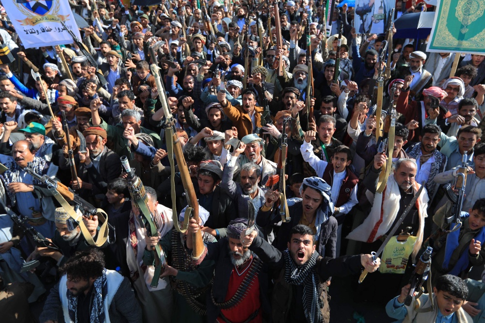 Supporters of the Houthi authorities brandish their weapons during a protest against Saudi intervention in Yemen, in Sanaa, on October 9, 2026. — AFP pic