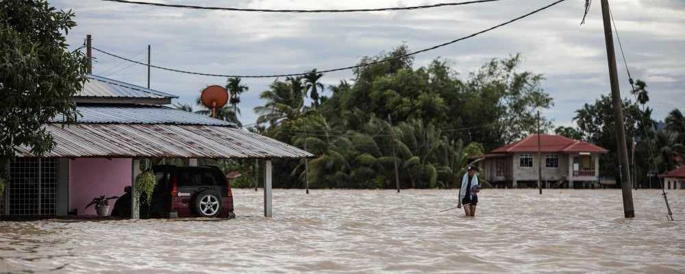 Woman dies after car swept away by floodwaters
