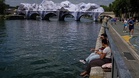 Crowds flock to JR's giant cave installation on Paris' Pont Neuf