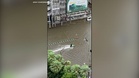 Jet ski rider cruises through flooded streets of Bangkok