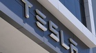 Tesla's profit drops as it explores a possible merger with Musk's other public company, SpaceX