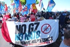 Tear gas and Tesla on fire as thousands march in Geneva to protest G7