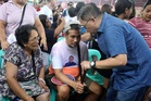 Go visits Manila fire victims amid rain, flood