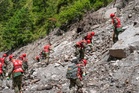 Missing in Nepal, China floods soars past 2,400