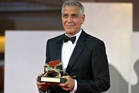 Clooney turns AFP photographer in jokey red carpet switch
