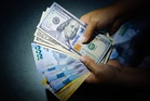 Peso sinks to new record low