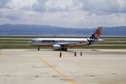 Crew member injured in near miss between planes on Sydney Airport runway