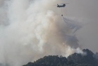 Thousands evacuate in Japan as forest fires close in on homes