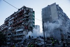 Photos of the aftermath of a Russian missile attack on a Kyiv apartment building