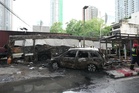 A cargo train hits a public bus at a Bangkok rail crossing, killing at least 8