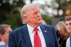 Majority of voters say Trump is using his office for personal gain as president promises ‘America is thriving’